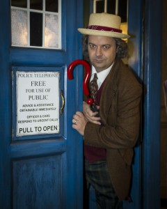 A fan dressed as Dr. Who peaks out of a replica of the character's time-traveling police box (Joe Nuzzo/Long Island Press).