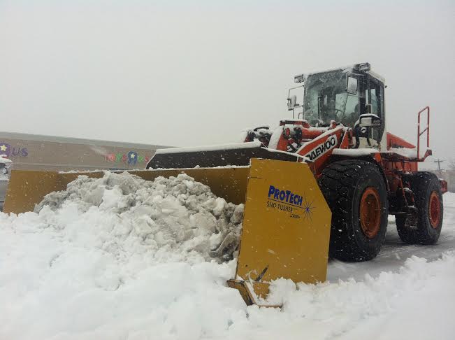 Heavy machinery was brought in to plow a parking lot in Bay Shore on Monday, Feb. 3, 2014.