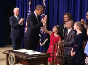 President Obama slaps hands with 8-year-old Hinna Zeejah of Oceanside. 