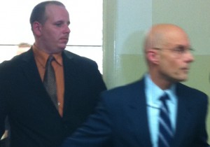 John Kaley, left, leaves Nassau County court to walk a gauntlet lined with police officers on Thursday, Feb. 21, 2013.