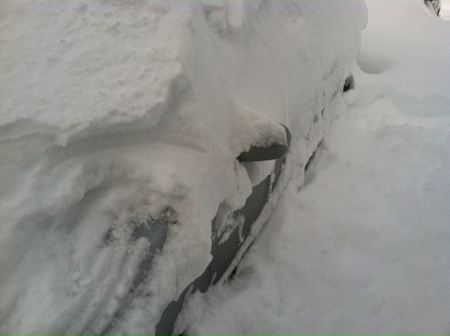 A car barely visible under a pile of snow in Commack. Monday, Feb. 11, 2013.
