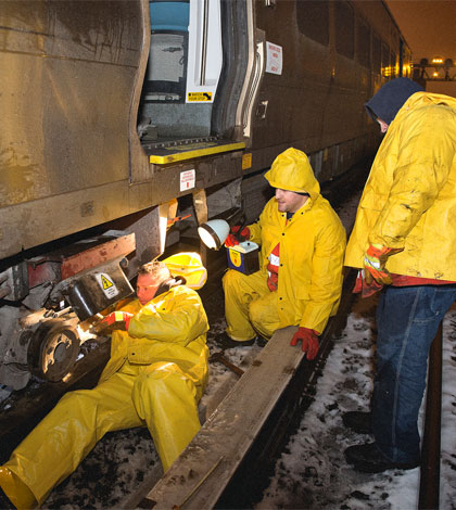 LIRR crews worked overnight in rain and sleet to re-rail a derailed train in Queens, on March 19, 2013. (MTA / Patrick Cashin.)