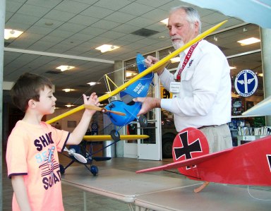 Matthew R. checks out the prop on one of the many Model Airplanes on display at the Cradles Annual
