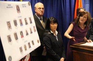 Kathleen Rice points to a board of mug shots at a news conference in her Mineola office Thursday, April 18, 2013.