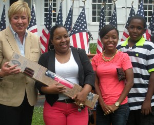 From left: Hempstead Town Supervisor Kate Murray, housing lettery winner Yolanda Ratcliff and her two children, 
