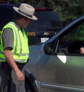 A New York State Trooper questions a driver.