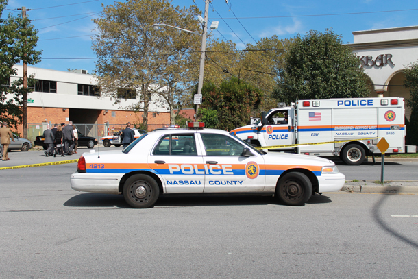 Nassau County police taped off the area where a gunman opened fire inside an East Garden City office Wednesday killing one and injuring another. (Rashed Mian/Long Island Press) 