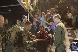 U.S. Marines help Philippine nationals displaced by Typhoon Haiyan exit an KC-130J Super Hercules aircraft at Villamor Air Base, Manila, Republic of the Philippines, Nov. 11, 2013. U.S. Marine Corps and Navy forces were deployed to the Philippines to support humanitarian efforts in response to Typhoon Haiyan.