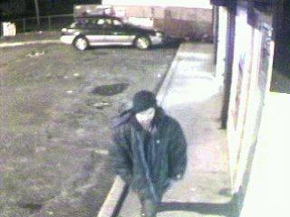Suffolk County police released a photo of an armed robbery suspect they believe is responsible for more than a dozen robberies in Suffolk.