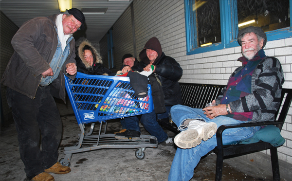 OUR HOUSE: A group of homeless people who refuse to stay in local shelters, including a woman who rides in a shopping cart after injuring her foot, warm up in the Hicksville train station’s platform-level waiting room.