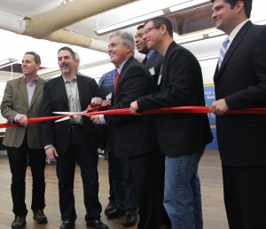 Suffolk County Executive Steve Bellone, center, cuts the ribbon at Launpad Huntington this week.