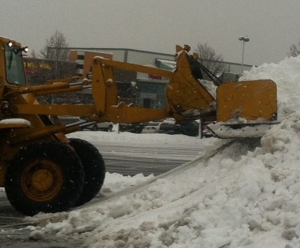 Plows attacking the snow during a previous storm. 