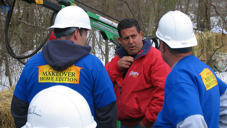 Alure Home Improvements President and CEO Sal Ferro (center) directs workers during one of the company's many projects for Extreme Makeover: Home Edition. (Long Island Press)  