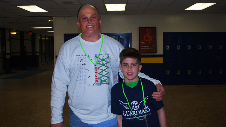Tim MacDowall and son Ryan, a fourth-grader at Longwood School District, showed their opposition to Common Core at a the "iRefuse!" rally March 29. Ryan opted-out of taking the state exams this year. (Jaime Franchi/Long Island Press)