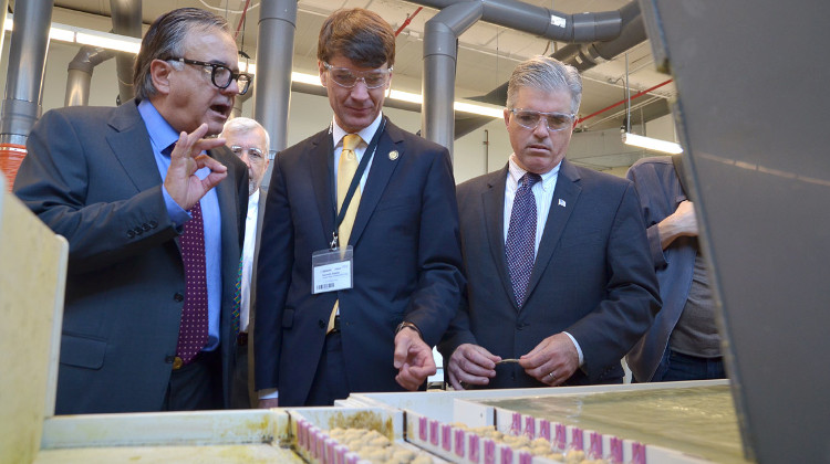 D'Addario & Company CEO and Chairman James D'Addario (L), Empire State Development Corp. President & CEO Kenneth Adams and Suffolk County Executive Steve Bellone inspecting the company's Farmingdale guitar string factory where its new NYXL electric guitar strings are made.