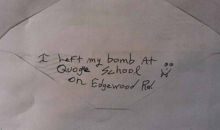 The above bomb threat against Quogue School was mailed to the Long Island Press in March 2013. A similar threat against Islip Town Hall exhibiting similar handwriting and other characteristics was received by the Press May 13, 2014. (Christopher Twarowski/Long Island Press) 