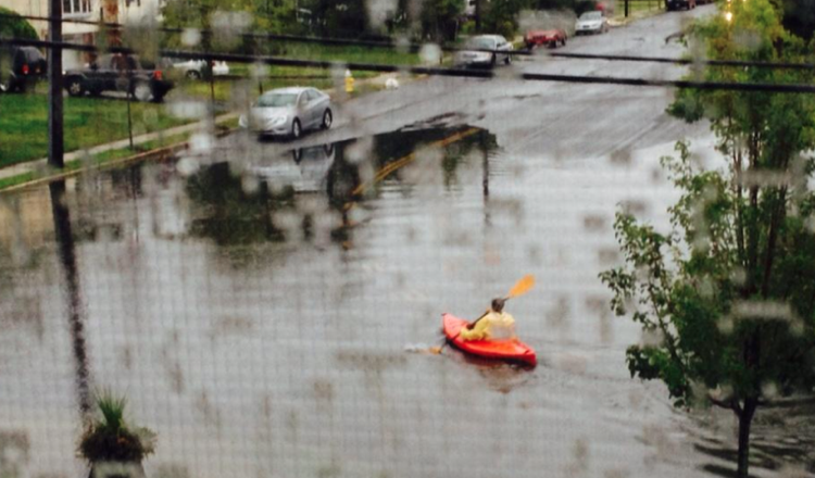 Resident floating on a kayak on Lagoon Place in East Islip. (Photo credit: Jaime Franchi)