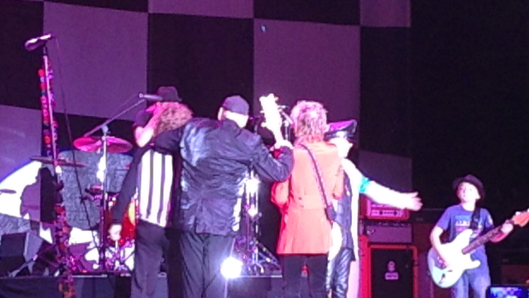Cheap Trick huddles together before a final bow wrapping up a stellar performance at The Paramount in Huntington, NY. (Christopher Twarowski/Long Island Press)