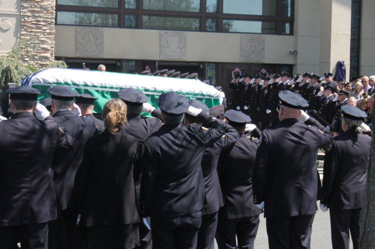 NYPD Officer Brian Moore's NYPD flag-draped casket being carried into St. James Roman Catholic Church in Seaford. (Rashed Mian/Long Island Press)