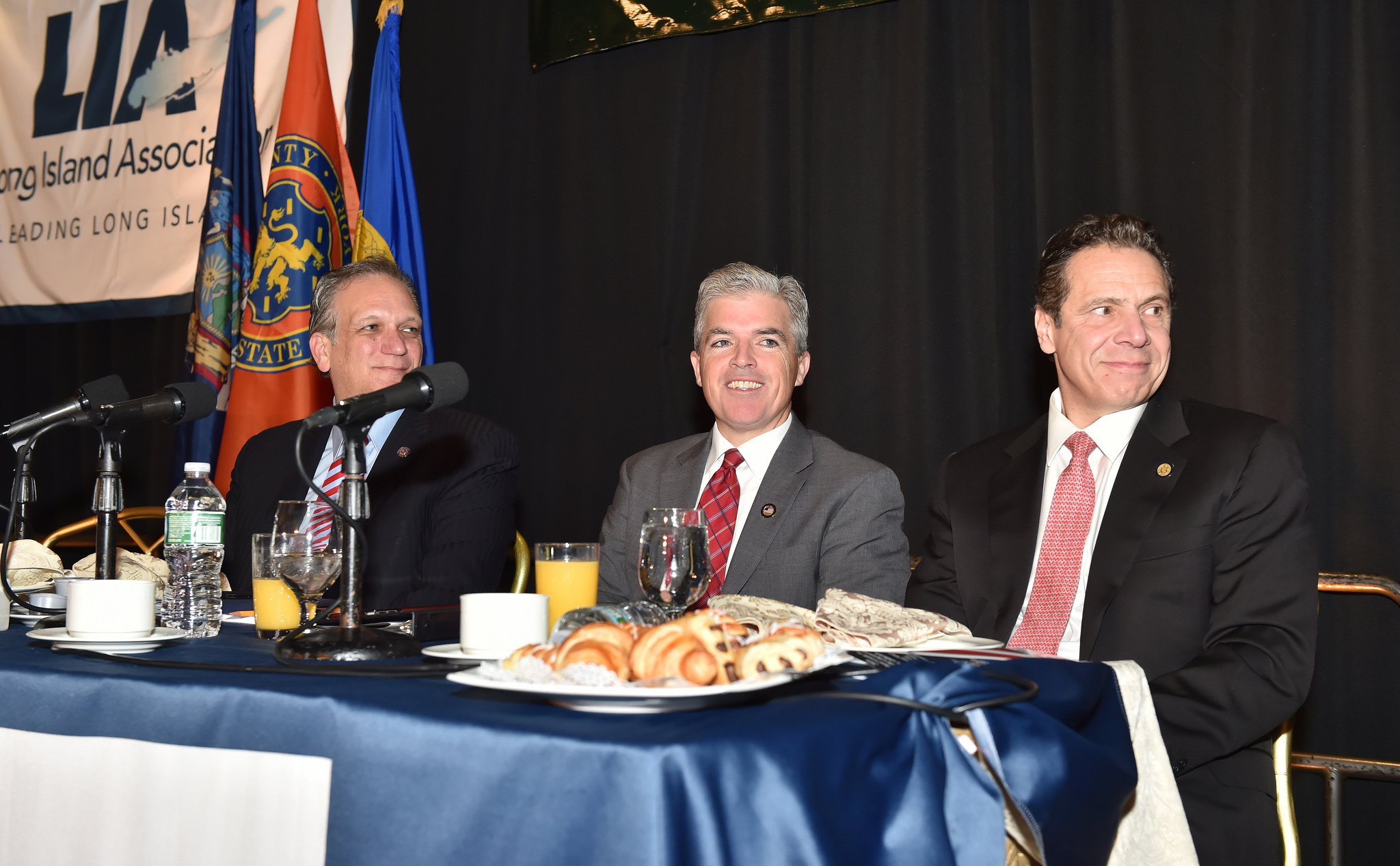 Nassau County Executive Ed Mangano (left) and his counterpart in Suffolk, Steve Bellone (center), join Gov. Andrew Cuomo at a breakfast unveiling the governor's 2016 agenda.  (Photo credit: Kevin P. Coughlin/Office of the Governor)
