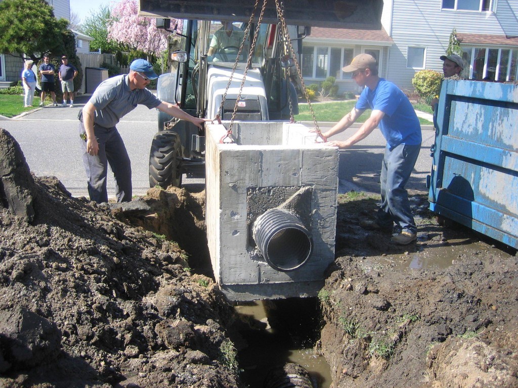 A construction crew installs a concrete vault that contains AbTech's smart sponges that filter pollutants out of stormwater drain pipes (AbTech photo).