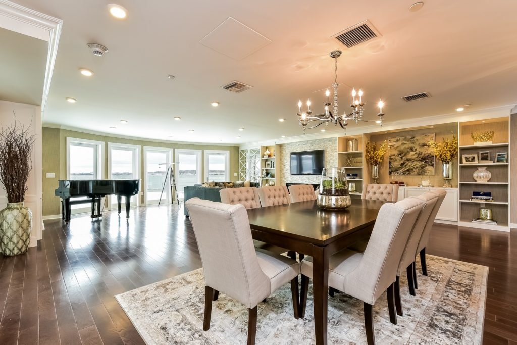 The open floor plan features built in cabinets comfortable seating a 60 inch Samsung television with sound system and grande windows offering beautiful views of Manhasset Bay.