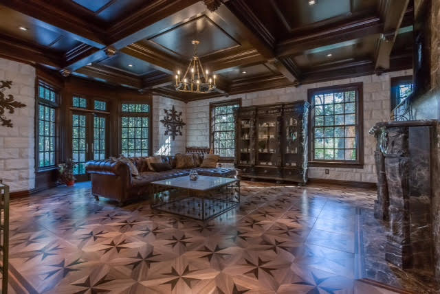 Familyroom with American Walnut parquet floor with African black wood inlay and marble fireplace mantle made of Emperador Marble.