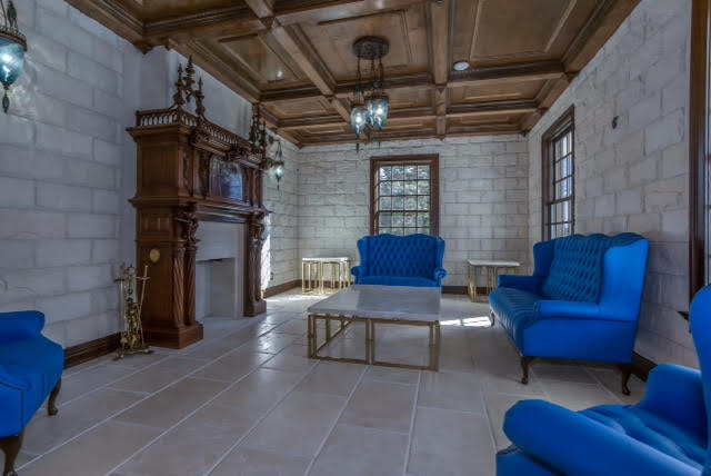 Front Parlor with hand cut limestone walls and marble fireplace.