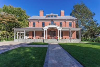 Front brick exterior with wrap around slate porch and roof and copper gutters.