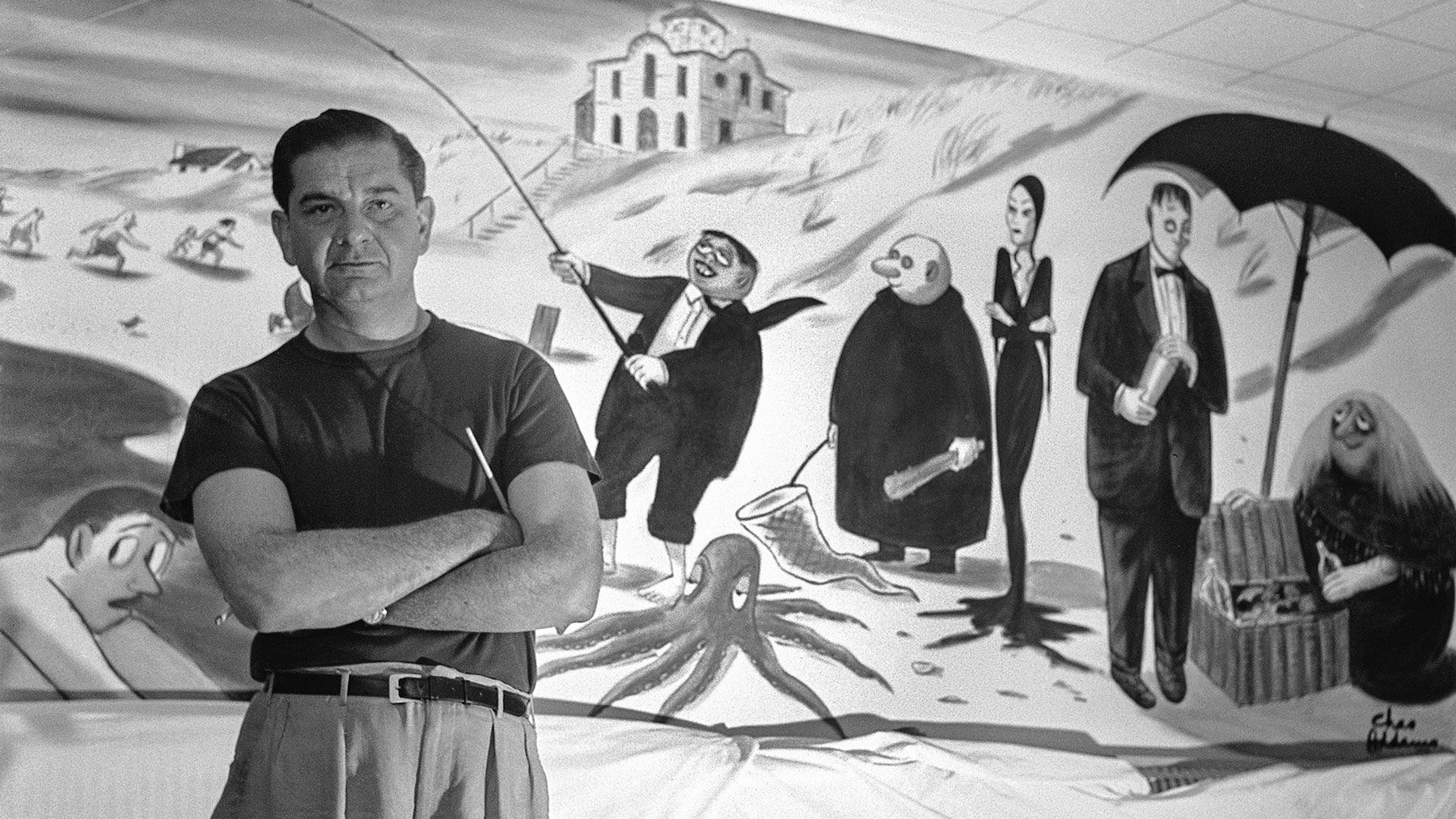 charles addams posing with a mural he painted that once hung in a hamptons hotel. look magazine library of congress