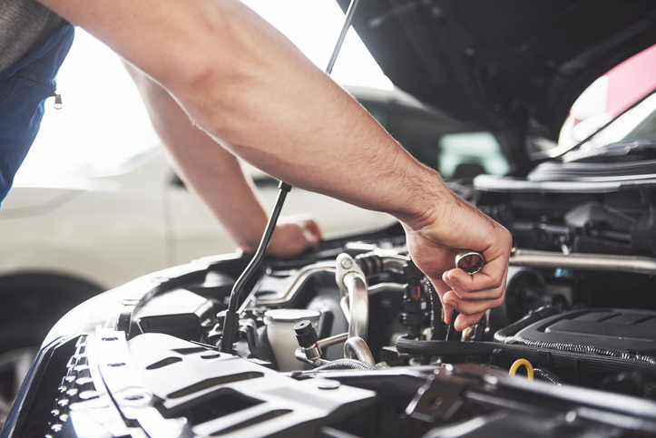 Auto mechanic working in garage. Repair service