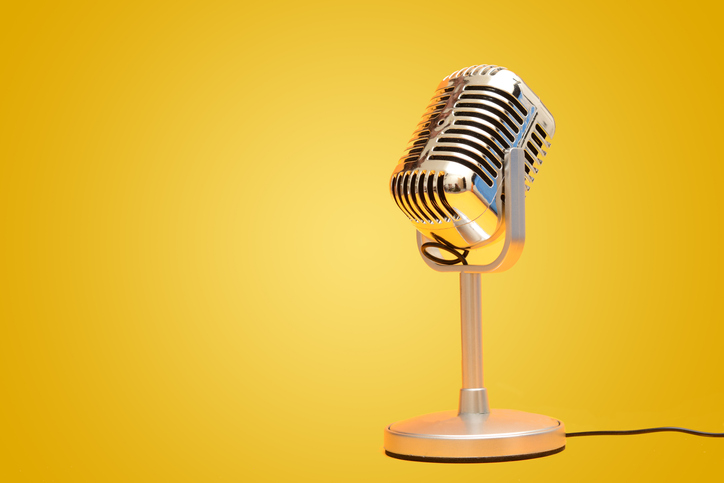 Retro vintage microphone on yellow background studio