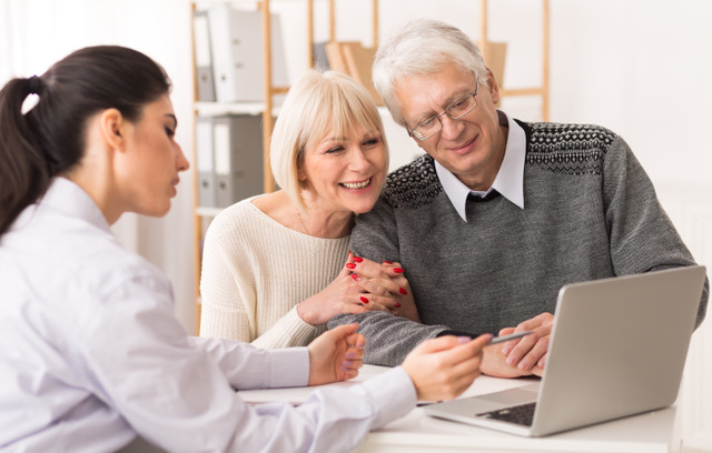 Senior couple meeting financial adviser for investment