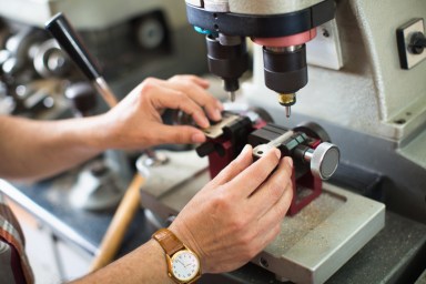 Professional skilled key cutter making door keys copies