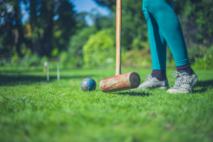 Young woman playing croquet