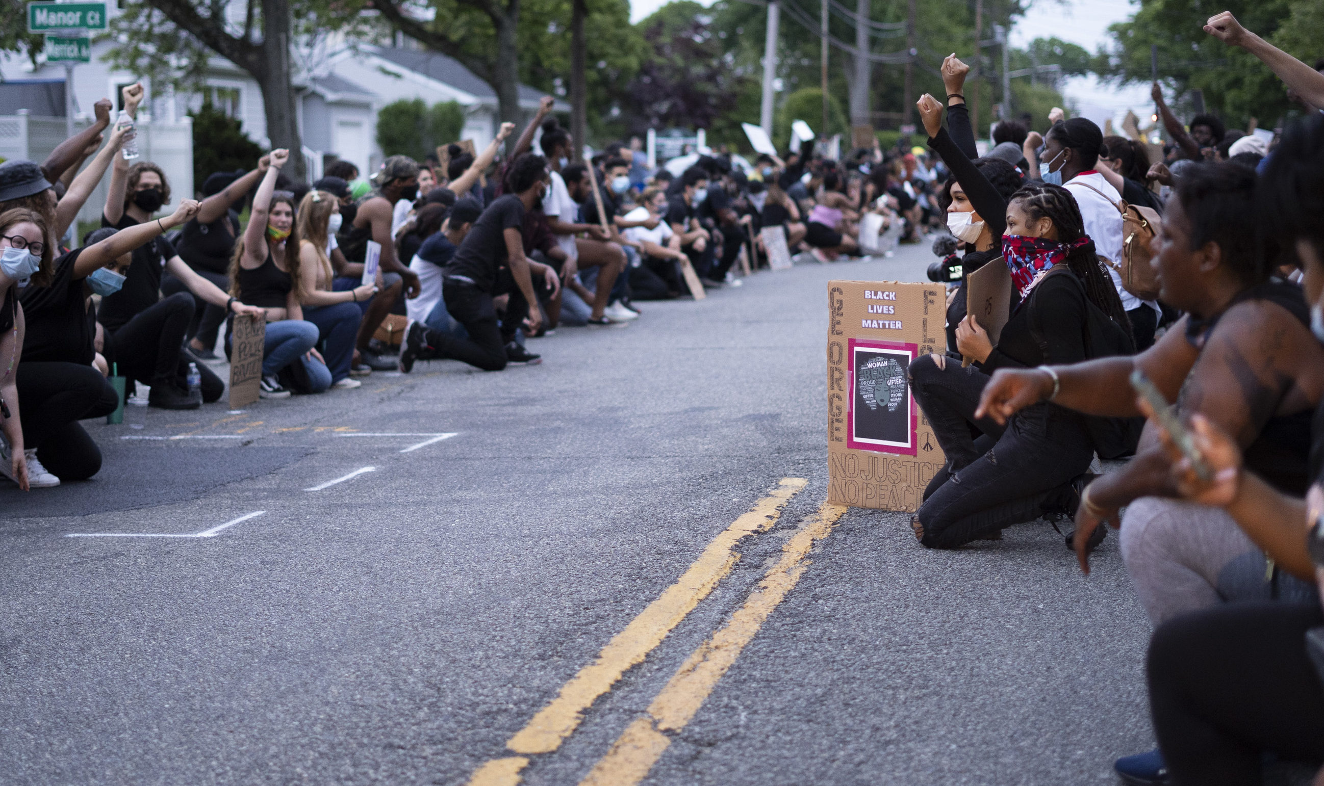 protestors kneeling on merrick ave e1591361749659