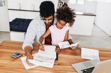 Worried father looking the finances with his baby girl