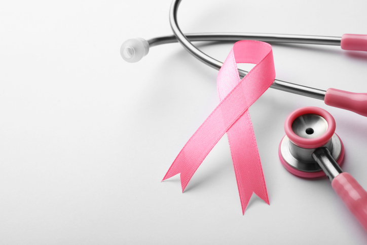 Pink ribbon and stethoscope on white background, space for text. Breast cancer concept