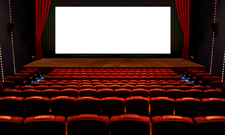 Theater hall with red seat and wide blank white screen