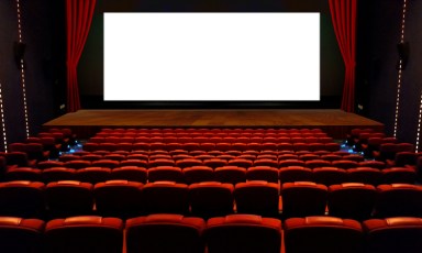 Theater hall with red seat and wide blank white screen