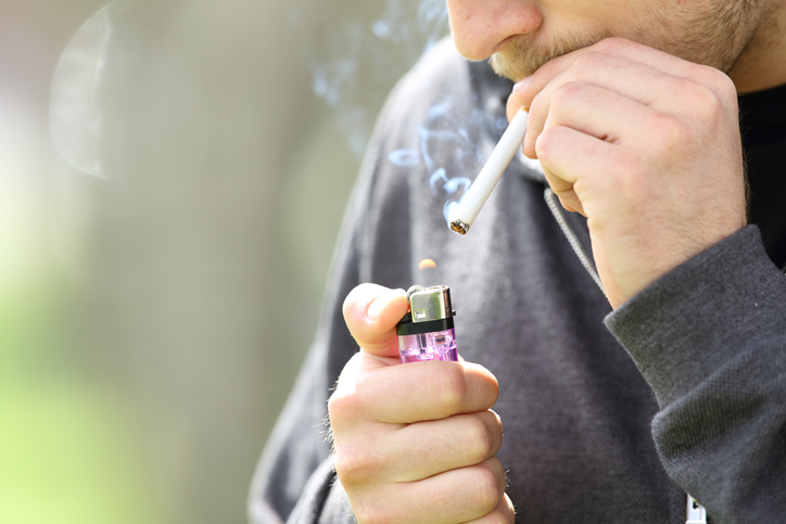 Teen hands lighting a cigarette to smoke