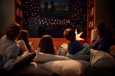 Family Enjoying Movie Night At Home Together