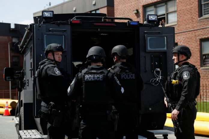 Law enforcement officers stand near the place where the shooter barricaded himself, after a shooting at a Stop and Shop grocery store, in Hempstead west hempstead stop & shop