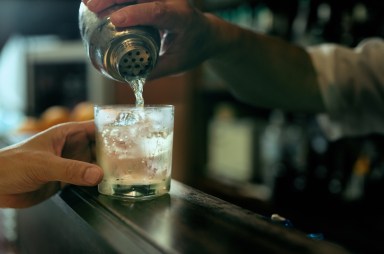 Close-up of bartender hand pouring cocktail