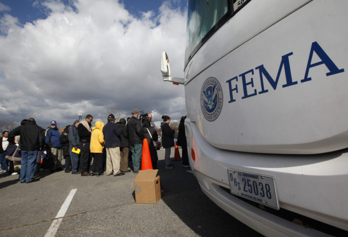 People wait in line to meet with FEMA officials in Coney Island, New York disaster recovery