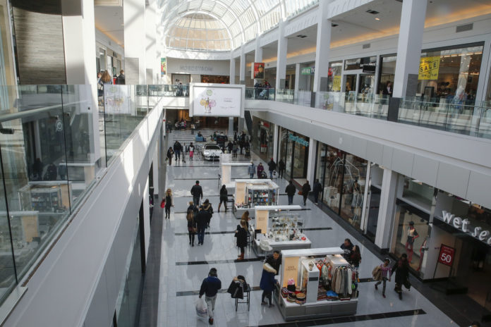 People are seen walking through Roosevelt Field shopping mall in Garden City, New York malls