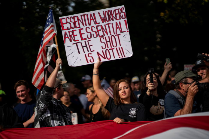 People march in protest of COVID-19 vaccine mandate, in New York workplace