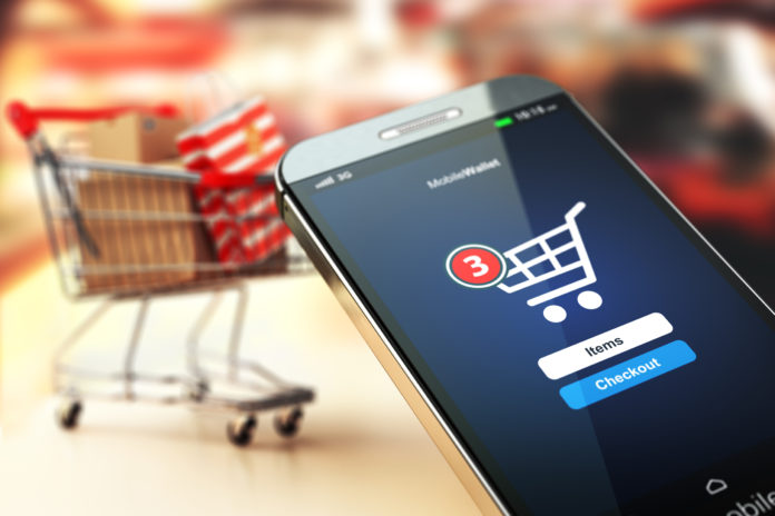 Online shopping concept nackground. Mobile phone or smartphone with cart and boxes and bag. retail