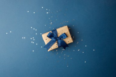 Happy Fathers Day concept – stylish craft gift box with bow on classic blue background, holiday, sale, discount concept, banner for our text, minimal, xmas, christmas, daddy day