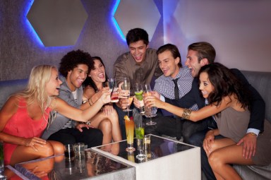 Friends toasting cocktails in nightclub